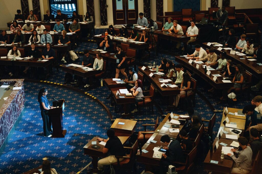 Adults Have Struggled to Set Rules for AI In School. These Teens Figured It Out Student addresses peers in a replica of the U.S. Senate chamber.