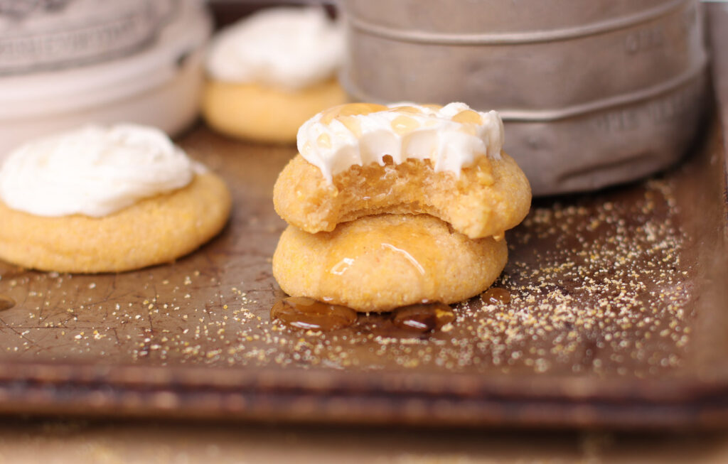 Easy Cornbread Cookies with Honey Buttercream Frosting frosted cornbread cookies on a tray