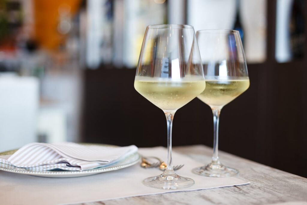 Two Glasses of White White wines on dining table in the restaurant,