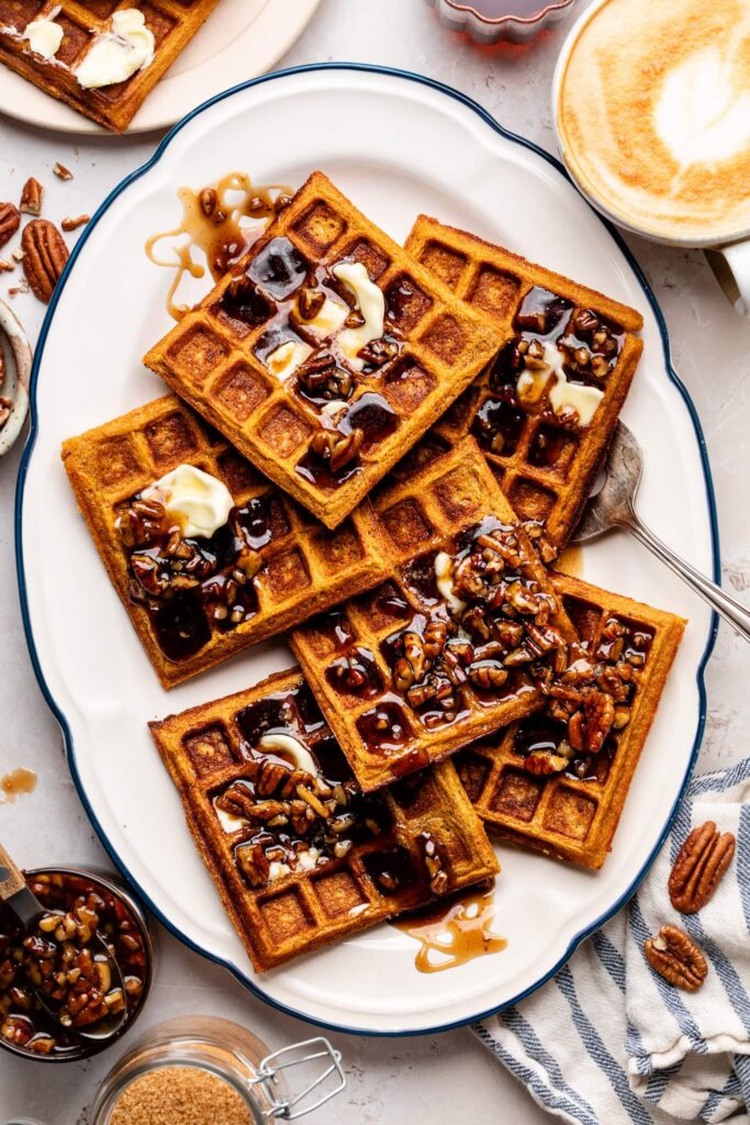 Sweet Potato Waffles with Butter Pecan Syrup sweet potato waffles with butter pecan syrup on platter