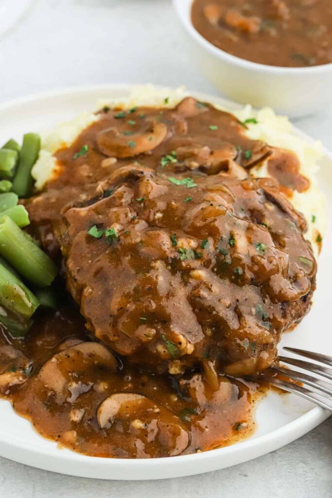 Salisbury Steak The best salisbury steak recipe with mashed potatoes and green beans topped with mushroom gravy