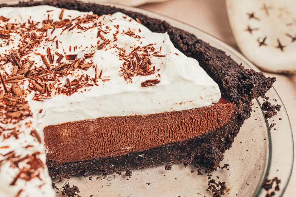 No Bake Chocolate Espresso Pie Part of a no bake espresso chocolate pie in a pie plate with a few pieces removed.