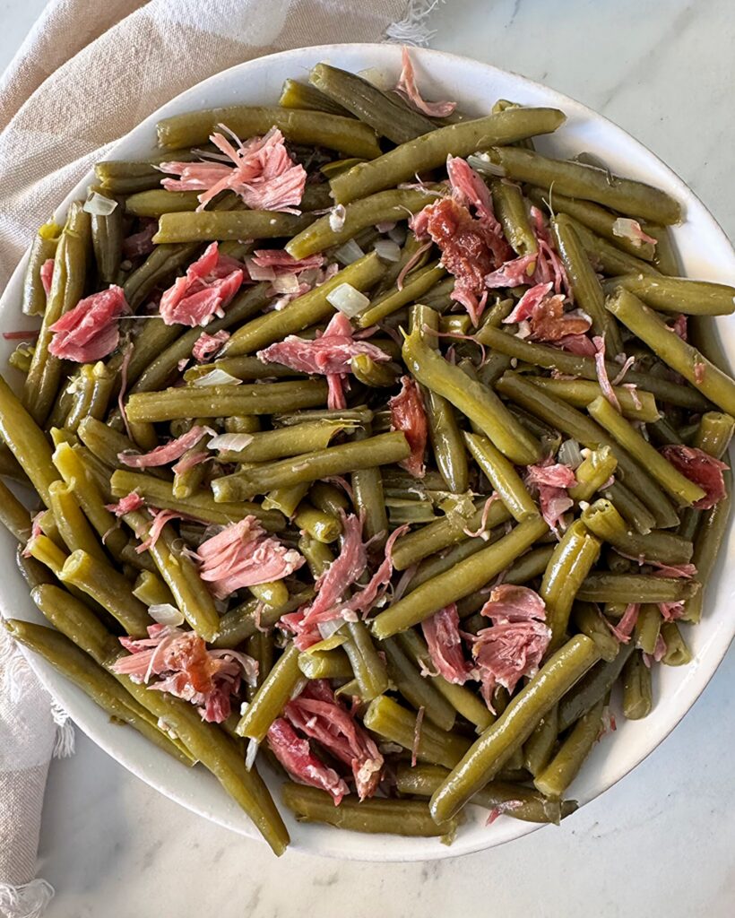 Slow Cooker Southern Green Beans overhead shot of cooked southern green beans in a white bowl